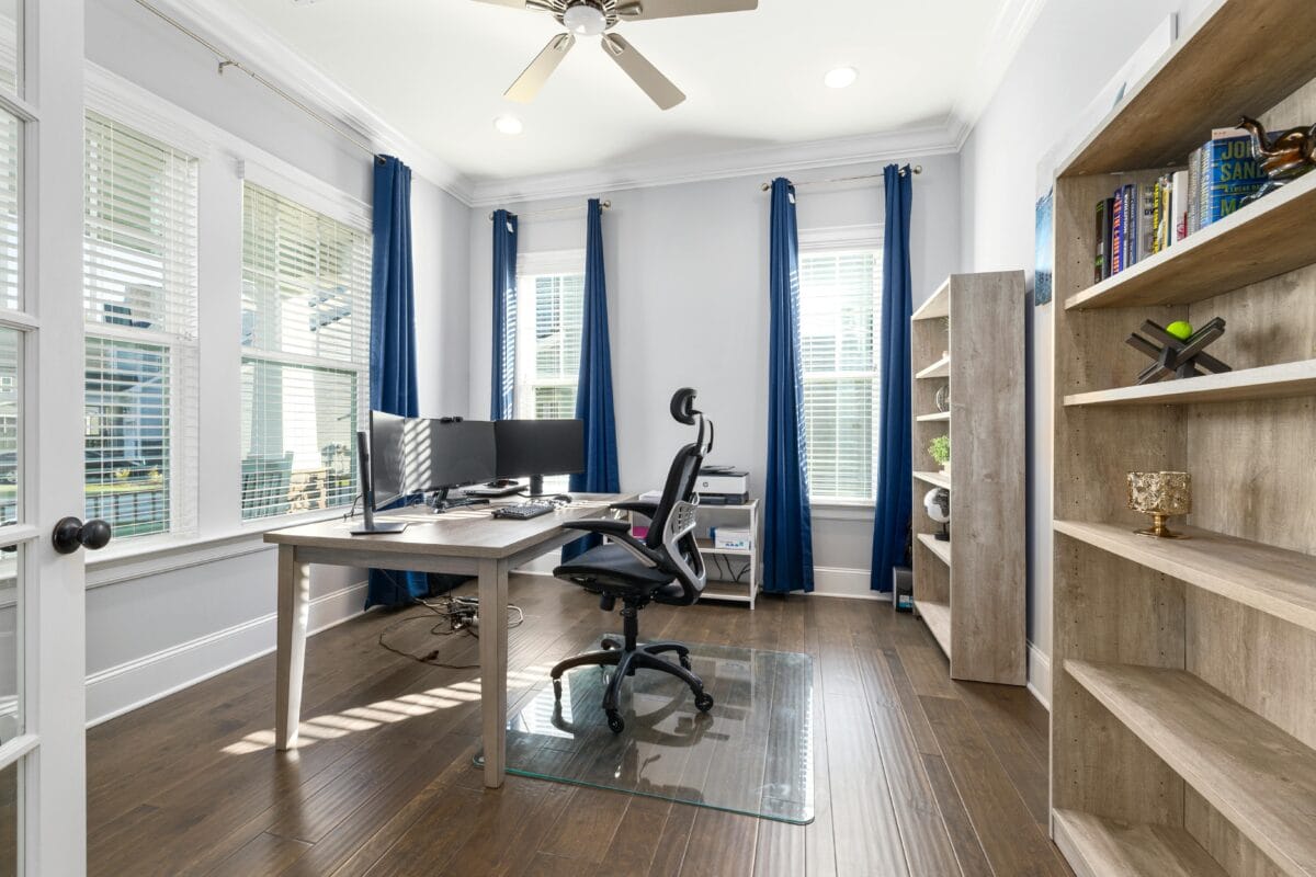 A bright and spacious modern office featuring light furnishings and ample windows, creating an open, airy atmosphere for a productive work environment.